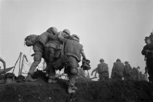 Leathernecks: Vietnam War. A US Marine is helped to an ?
