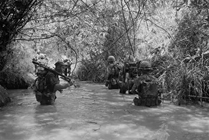 Quang: Vietnam War. US Marines move through water ?