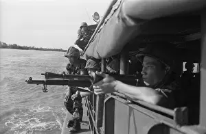 Anti Communist: Vietnamese soldiers inspecting the shoreline from