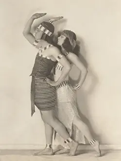 Ov1607: Side view of dancers posing against white wall