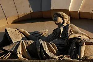 Edme: View from below of a female figure on the pediment