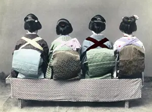 Back view of four geishas, showing their obi sashes, Japan