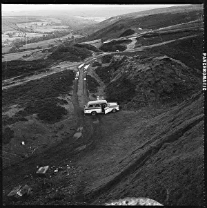 A view looking down towards a car parked beside