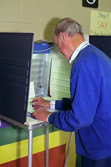 Obligation: Side View Older Senior Man Voting in Portable Polling Booth