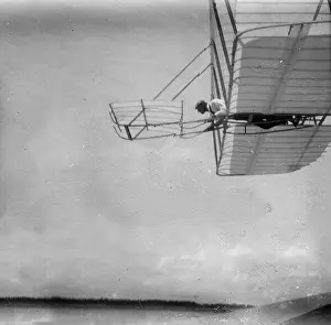 Piloting: Side view of Wilbur Wright piloting a glider in level flight