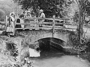 Socialising: Villagers on a bridge over a stream, 1890s