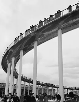 Stilts: Visitors on a pedestrian bridge on the site of the World Exh