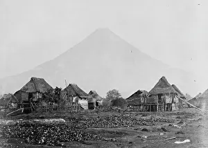 Moluccas: Volcano with straw roofed house in foreground, Moluccas, Ind
