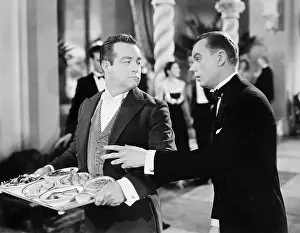 Sustenance: A waiter and patron at a gala event