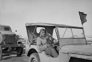 Corridor: War photographer sitting in Jeep somewhere