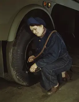 Tanker: War production worker checking the tires of
