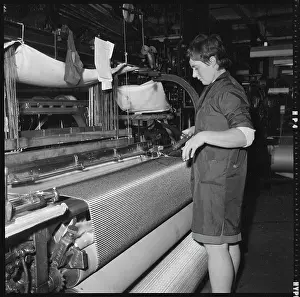 Cowling: A weaver preparing a shuttle for use in a power loom