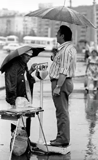 Weighing: Weighing in street, 1981