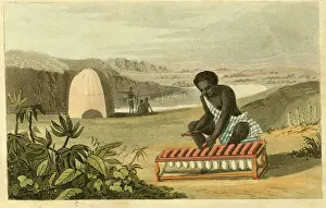 Xylophone: West African native playing Balafon