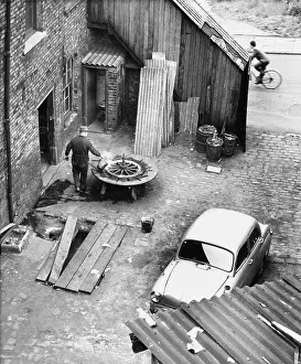 Corrugated: Wheelwright in garage yard - Manchester