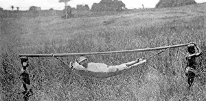 A white man is carried in a hammock, 1923