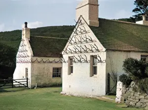 Whitewashed: Two whitewashed cottages with antler display