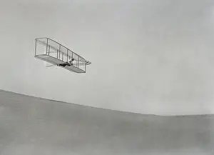 Firsts: Wilbur Wright gliding above the slope of Big