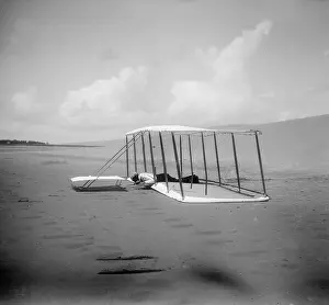 Skid: Wilbur Wright in prone position on glider just after landing