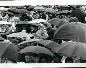 Wimbledon tennis spectators with umbrellas