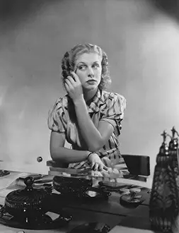 Eyebrow: Woman applies makeup at her dressing table