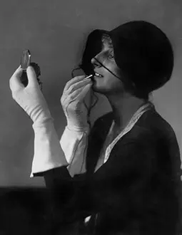 Herself: A woman applying makeup, 1935