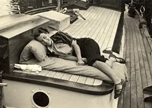 Cushions: Woman asleep on board boat