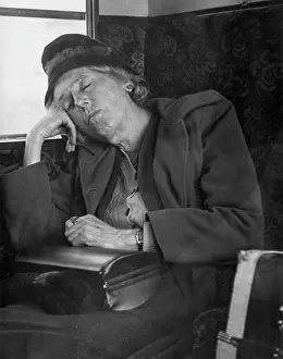 Snoozing: Woman asleep on a train