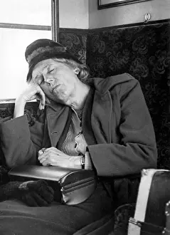 Snoozing: Woman asleep on a train