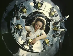 Accuracy: A woman assembles part of the cowling for