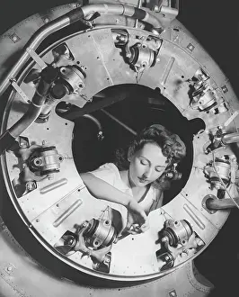 Accuracy: A woman assembles part of the cowling of a