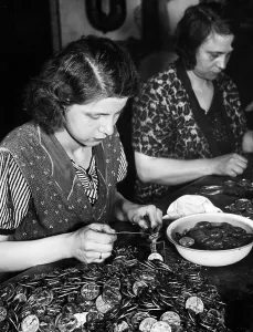 Plaques: Woman assembling plaques, 1934