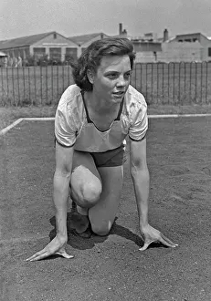 Poised: Woman athlete in starting position