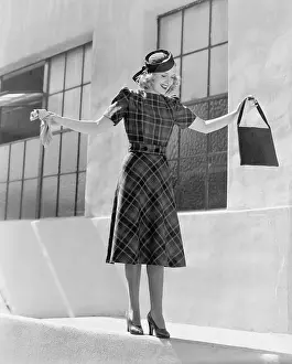 Handbags: Woman balancing on edge of wall