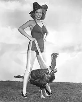 Leggy: Woman in bathing suit walking a turkey