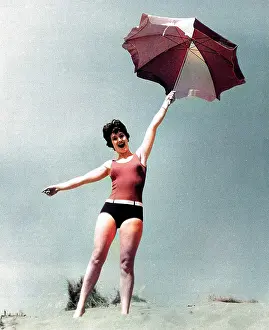 Andrew Besley: Woman on beach with sunshade