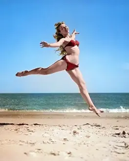 Voluptuous: Woman in Bikini Running and Jumping on the