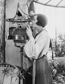 Caged: Woman with bird in cage