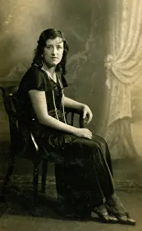 Satin: Woman in black dress and pearls