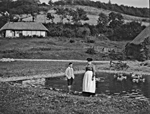 Duckpond: Woman and boy standing by a duckpond