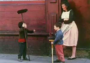 Brushes: Woman and two boys with sweeping brushes