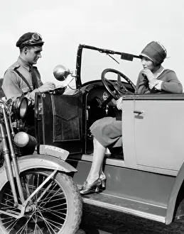 Violation: Woman in car getting ticketed by motorcycle cop