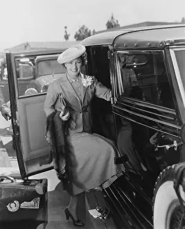 Affluence: Woman with car and luggage