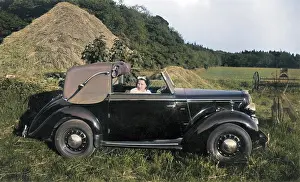 Haystack: Woman in a car near a haystack