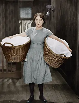Overworked: Woman carrying laundry baskets