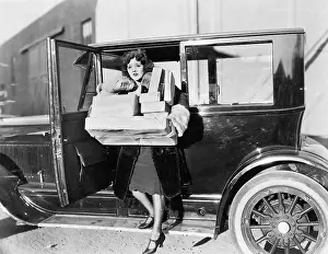 Generosity: Woman carrying packages from car