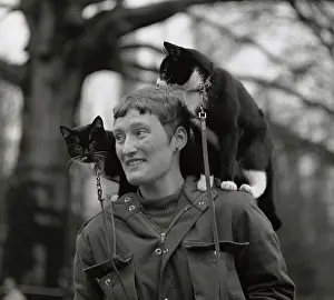 Anorak: Woman with a cat on either shoulder