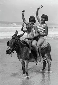 A woman and two children riding on