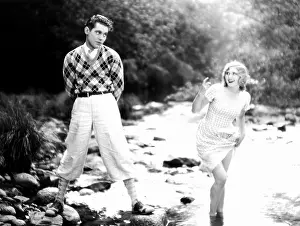 Tentative: Woman coaxing man into a stream