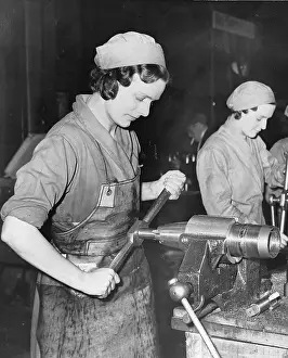 Chiefly: Woman constructing a shell casing in Factory